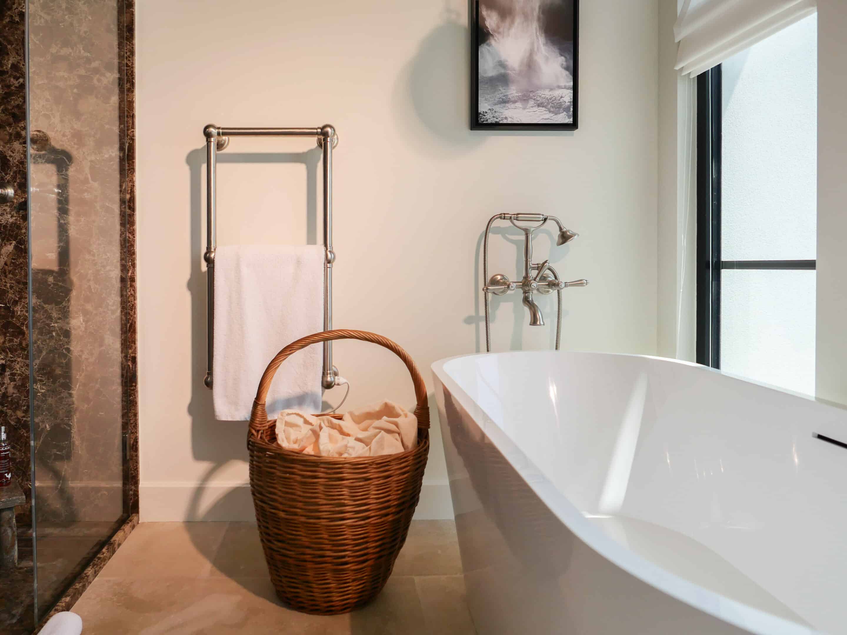 In keeping with the rest of the house, a quiet and serene second guest room with the same mix of vintage and custom designs. A bespoke dark blue bouclé bed and headboard by KS STUDIO DESIGN is paired with original Reguin side tables.The bespoke headboard fits the width of the room perfectly.